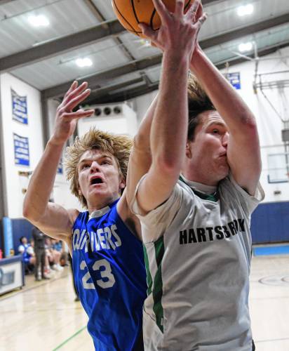 Four Rivers’ Russell Herbert fights for a rebound with Hartsbrook’s Oskar Codding during the River Valley Athletic League championship game in Greenfield on Thursday.