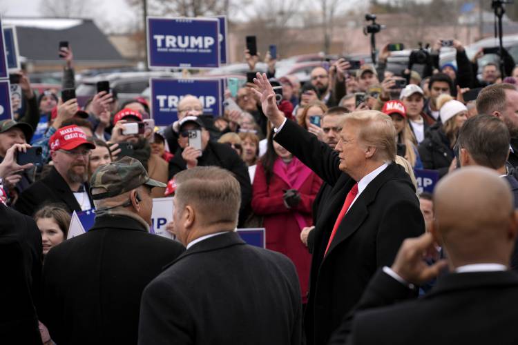 Republican presidential candidate former President Donald Trump greets supporters as he arrives at a campaign stop in Londonderry, N.H., Tuesday, Jan. 23, 2024.
