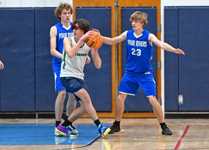 Hartsbrook’s Das Khalsa is defended by Four Rivers’ Meir Dragon, left, and Russell Herbert during the River Valley Athletic League championship game in Greenfield on Thursday.