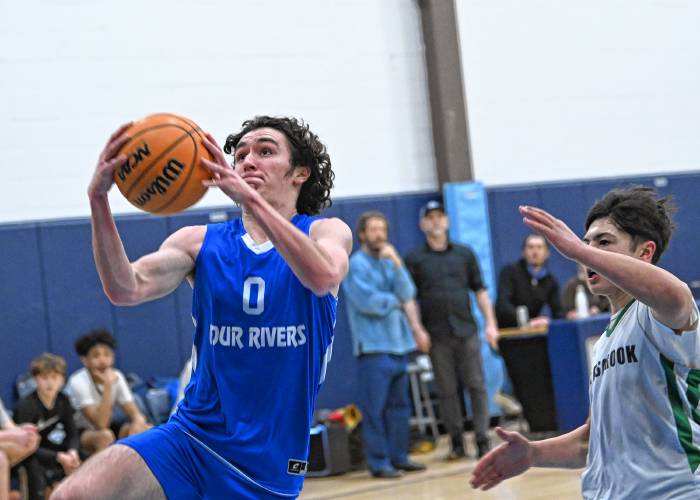 Four Rivers’ Cooper Whitney goes up for two against Hartsbrook during the River Valley Athletic League championship game in Greenfield on Thursday.