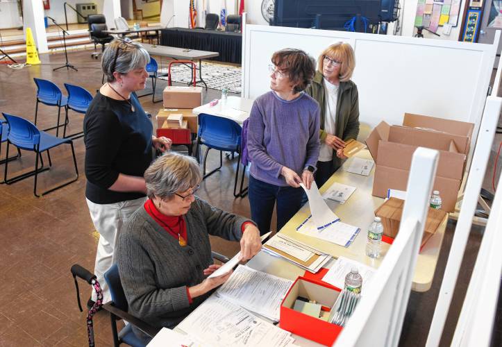 Deerfield Town Clerk Cassie Sanderell, left, talks with members of the League of Women Voters as Marge Michalski, Denise Petrin and Ruth Odom help process vote-by-mail applications in the Deerfield Town Hall on Feb. 5.