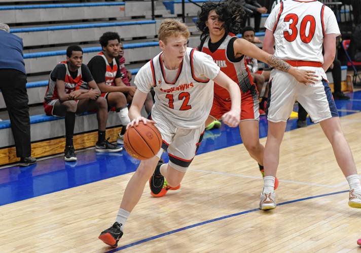 Frontier’s Garrett Dredge (12) rolls around the pick against Madison Park Tech during the Redhawks’ 81-46 victory in the MIAA Division 4 preliminary round on Tuesday night at Goodnow Gymnasium in South Deerfield.