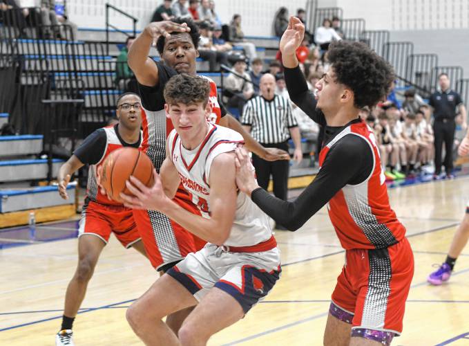 Frontier’s Owen Babb is surrounded by Madison Park Tech defenders during the Redhawks’ 81-46 victory in the MIAA Division 4 preliminary round on Tuesday night at Goodnow Gymnasium in South Deerfield.