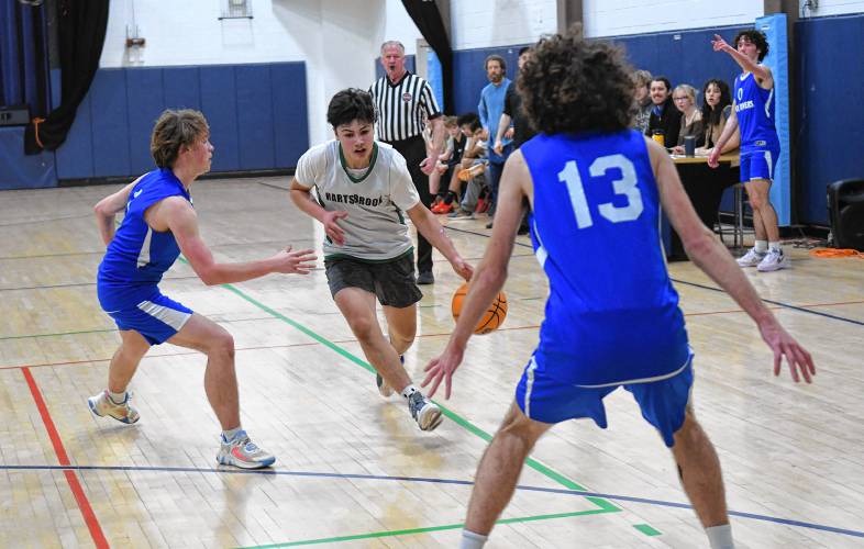 Hartsbrook’s Cayden Perez splits two Four Rivers defenders during the River Valley Athletic League championship game in Greenfield on Thursday.