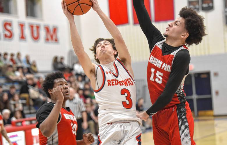 Frontier’s Nico Fasulo is fouled by Madison Park Tech’s Devoney DeBaros during the Redhawks’ 81-46 victory in the MIAA Division 4 preliminary round on Tuesday night at Goodnow Gymnasium in South Deerfield.
