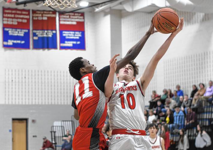 Frontier’s Max Millette tries to get a shot past Madison Park Tech’s Amir Mohamed during the Redhawks’ 81-46 victory in the MIAA Division 4 preliminary round on Tuesday night at Goodnow Gymnasium in South Deerfield.
