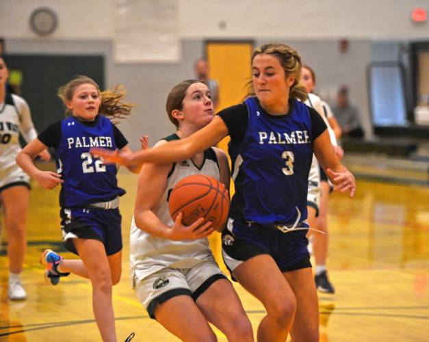 Greenfield's Anna Bucala attacks the basket while defended by Palmer's Madison Rathbone on Friday at Nichols Gymnasium in Greenfield. 