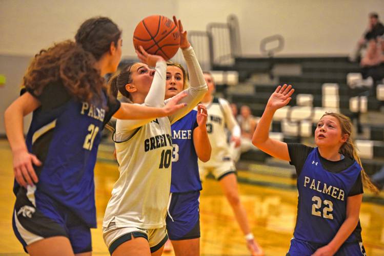 Greenfield's Elderina Cecunjanin goes up for a shot in traffic while guarded by Palmer's Lillian Pronovost (left) and Harper Brouillette (right) on Friday at Nichols Gymnasium in Greenfield. 