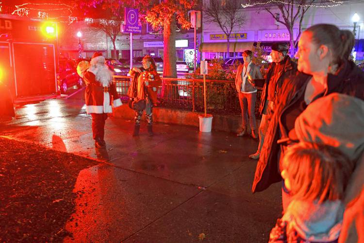 Santa Claus arrives by Greenfield Fire Department truck at Veterans Mall on Friday night for the annual tree lighting, kicking off the weekend’s Jinglefest activities.