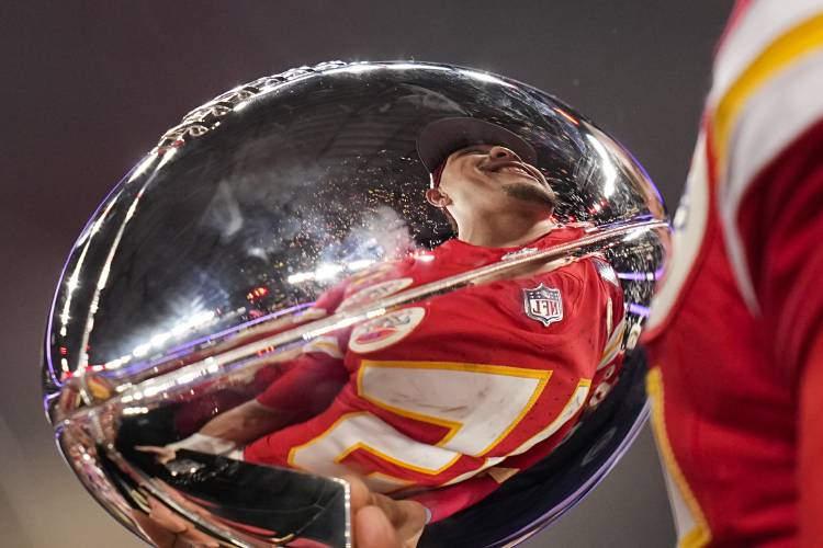 Kansas City Chiefs quarterback Patrick Mahomes is reflected in the Vince Lombardi Trophy after the NFL Super Bowl 58 football game against the San Francisco 49ers Sunday, Feb. 11, 2024, in Las Vegas. The Chiefs won 25-22 against the 49ers. (AP Photo/Eric Gay)