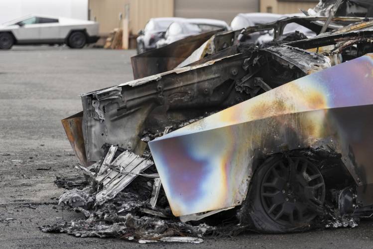 A burned Tesla Cybertruck is parked at a Tesla lot in Seattle, Monday, March 10, 2025.