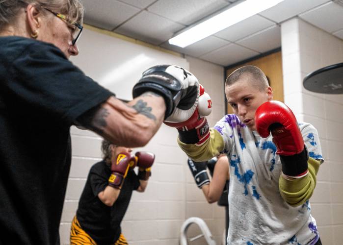 Sam Gerdes, right, and Nina Rossi practice together during a women's boxing class at Franklin County’s YMCA in Greenfield.