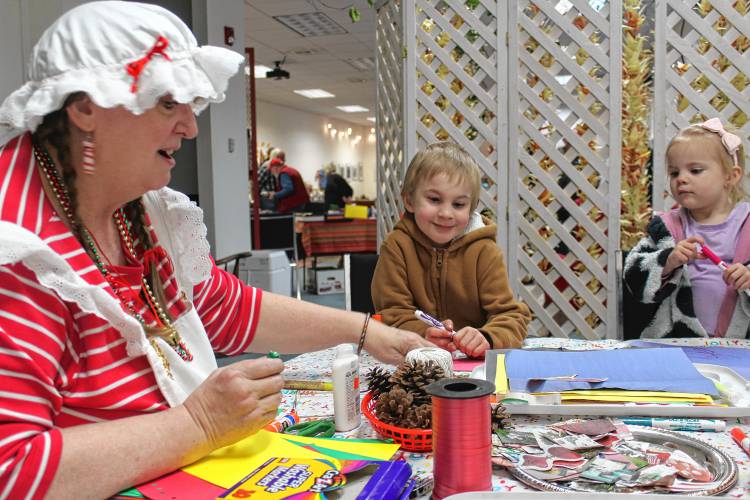 Jovonna Van Pelt as Mrs. Claus and Greenfield residents Jonathan Doel, 7, and Elizabeth Doel, 2, make crafts at The LAVA Center on Saturday as part of Jinglefest.