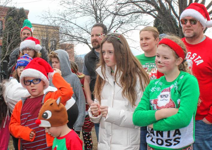 Competitors listen to the rules of The Amazing Race: Jinglefest Edition on Saturday.