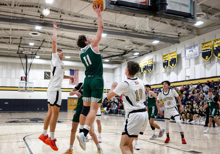 Greenfield’s Jonathan Breor drives to the hoop for his 1,000th career point in the second quarter against Pioneer on Monday night in Northfield.