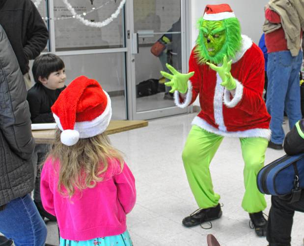 The Grinch meets children at Franklin County’s YMCA on Saturday as part of Jinglefest.