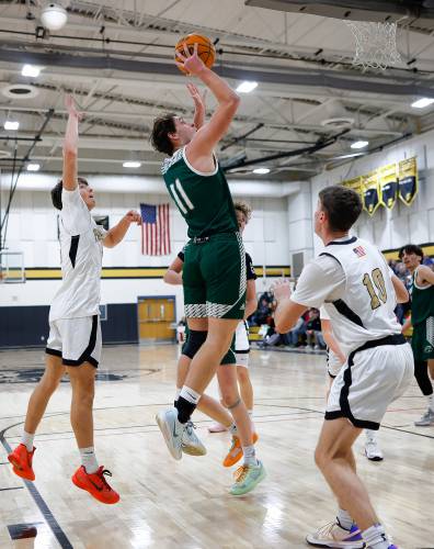 Greenfield’s Jonathan Breor drives to the hoop for his 1,000th career point in the second quarter against Pioneer on Monday night in Northfield.