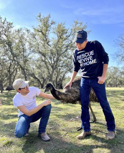 Winding Branch Ranch co-founders Matthew Aversa, left, and his husband, Tim Kessler, appear with an emu on their Winding Branch Ranch in Bulverde, Texas on Dec. 6, 2023. 