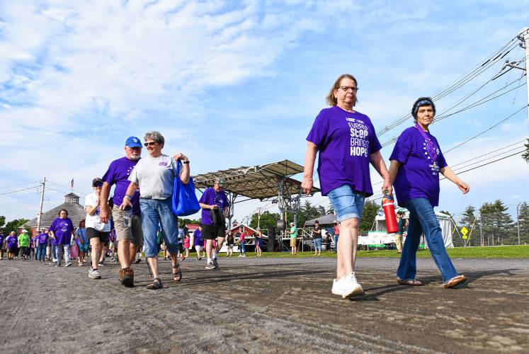 Walkers take part in the Relay For Life of Franklin County Survivor Lap at the Franklin County Fairgrounds on Friday evening.