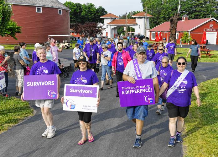 Walkers take part in the Relay For Life of Franklin County Survivor Lap at the Franklin County Fairgrounds on Friday evening.
