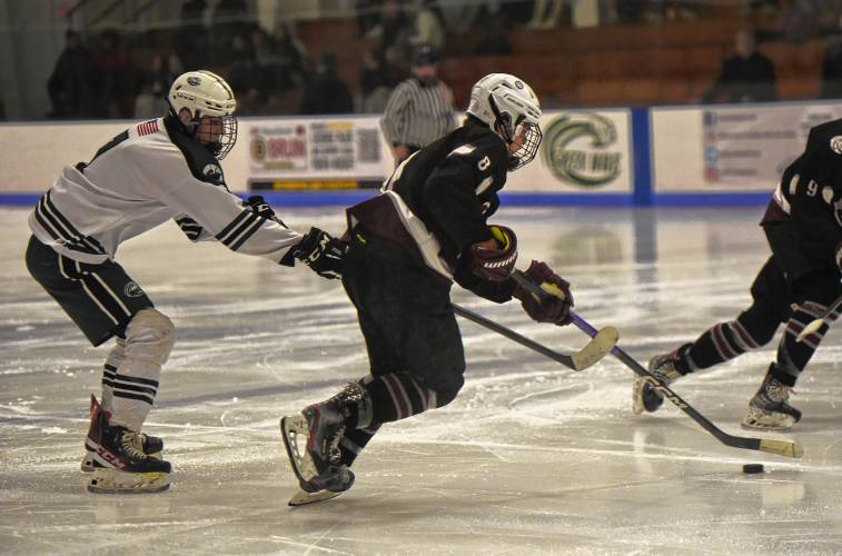 Amherst’s Jack Dyjach (8) moves the puck toward the Greenfield net during the visiting Hurricanes’ 3-1 victory on Monday at Collins-Moylan Arena in Greenfield.
