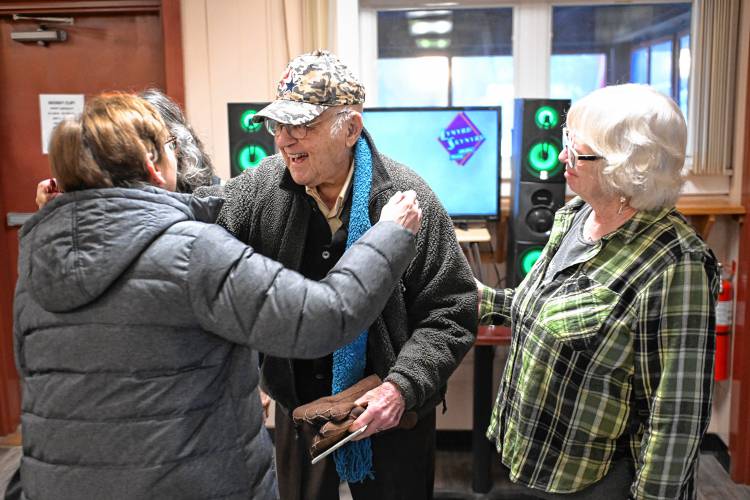 Lee Evers, who turned 102 on Feb. 12, is greeted at his birthday party at St. Kazimierz Society in Turners Falls. At right is his “adopted daughter” Linda Rice of Greenfield.