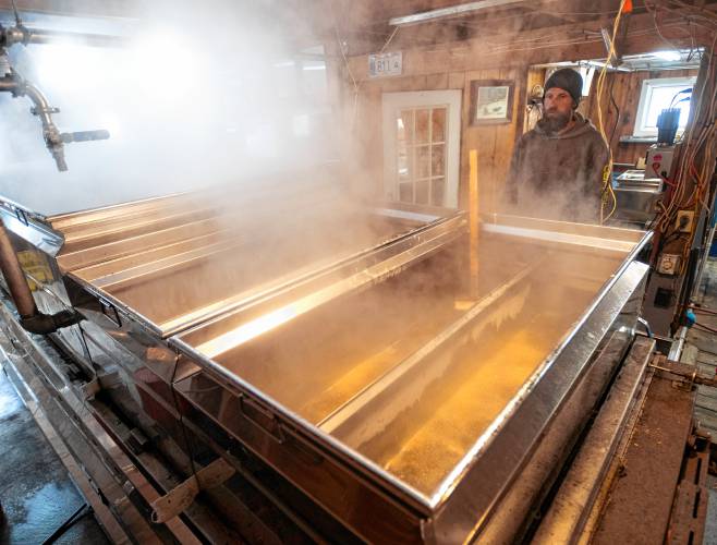 Jamison Smith watches over boiling sap at Paul’s Sugar House in Williamsburg.