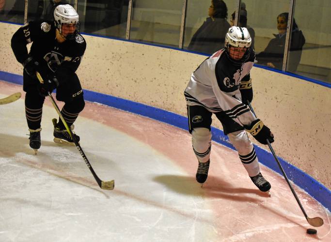 Greenfield’s Jack Laurie (4), right, carries the puck against Amherst during the visiting Hurricanes’ 3-1 victory on Monday at Collins-Moylan Arena in Greenfield.