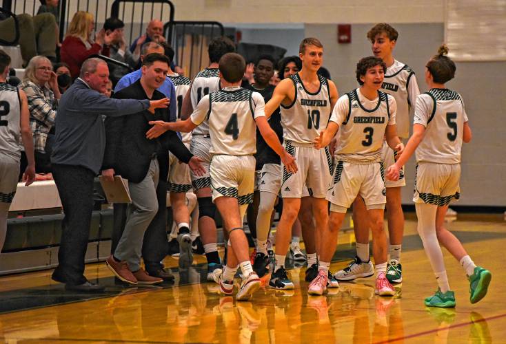 Greenfield players celebrate a fast start to the game against Lenox during the Green Wave’s Hampshire League South victory on Friday night at Nichols Gymnasium in Greenfield.