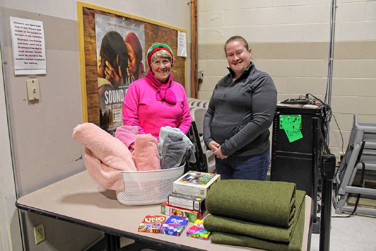 From left, Greenfield Mayor Ginny Desorgher and Christy Lemoine, volunteer coordinator with the Medical Reserve Corps unit serving Franklin and Berkshire counties, oversee the Overnight Warming Center set up at the Greenfield Salvation Army location at 72 Chapman St. on Sunday night.