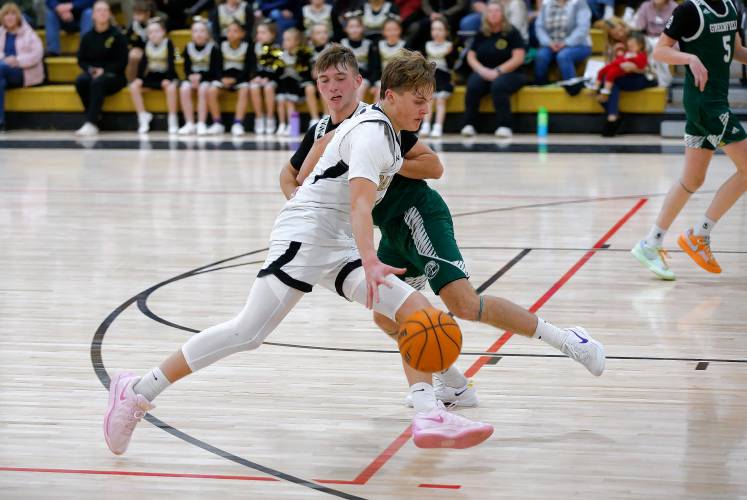 Pioneer’s Jackson Glazier (4) dribbles under pressure from Greenfield’s Caleb Murray (4) in the fourth quarter Monday in Northfield.