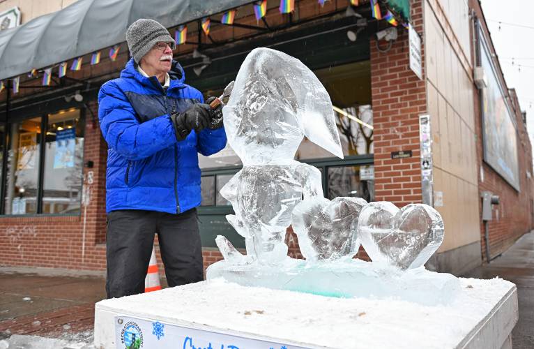 Peter Vacchina works on his ice sculpture on Main Street in Greenfield.