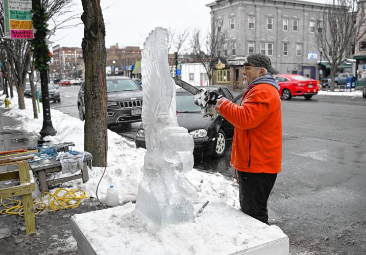 Billy Poe of Three Rivers carves an eagle out of ice on Main Street in Greenfield.