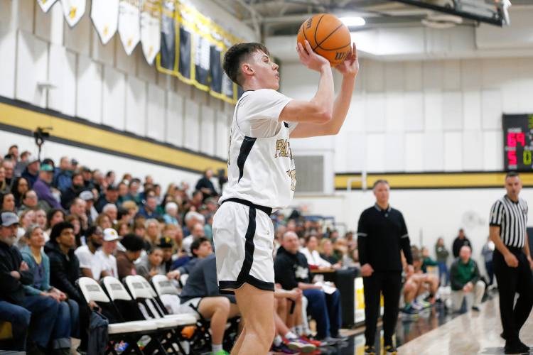 Pioneer’s Brayden Thayer (10) puts up a three point shot against Ware in the fourth quarter of the MIAA Division 5 quarterfinal Friday night in Northfield.