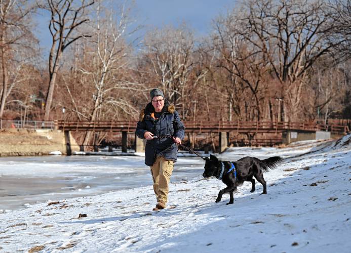 Moon Wymore of Greenfield walks her rescue dog Maybe at the Green River Swimming and Recreation Area on Friday.