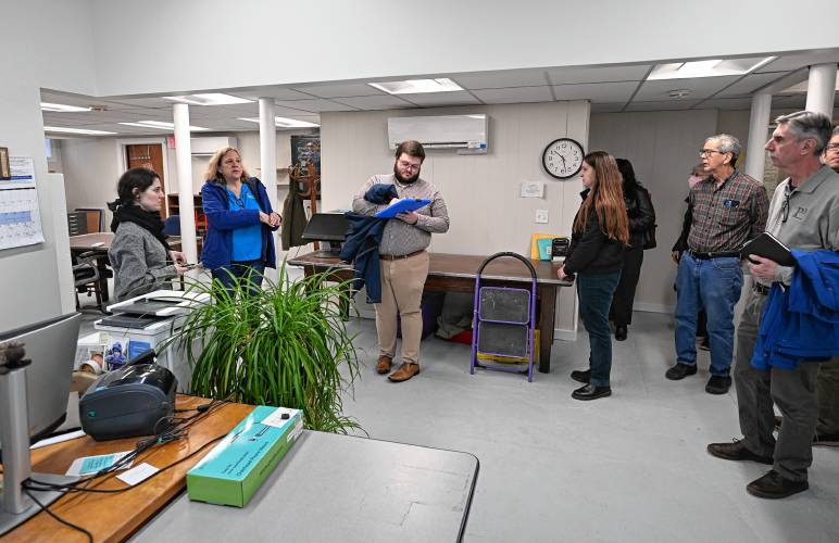 Montague Public Libraries Director Caitlin Kelley, left, answers questions as officials tour the basement of the Carnegie Public Library on Wednesday.