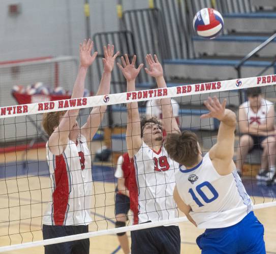 Frontier's William Reading, left, and Jonathan Olvera (19) attempt to block a spike from West Springfield's Daniel Gargun (10) during the volleyball game at Frontier High School, Tuesday, April 8, 2025, in South Deerfield.