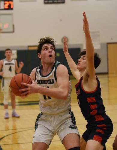 Greenfield’s Jon Breor looks to shoot over Mahar’s Marshall Ames in Greenfield last year.  