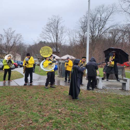 The Expandable Brass Band plays for the crowd during Saturday’s “Hands Off!” protest along Route 116 in Conway.