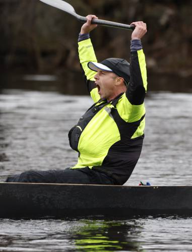 Adam Gelinas celebrates after crossing the finish line in first place with Patrick Madden during the 60th annual River Rat Race in Orange on Saturday.
