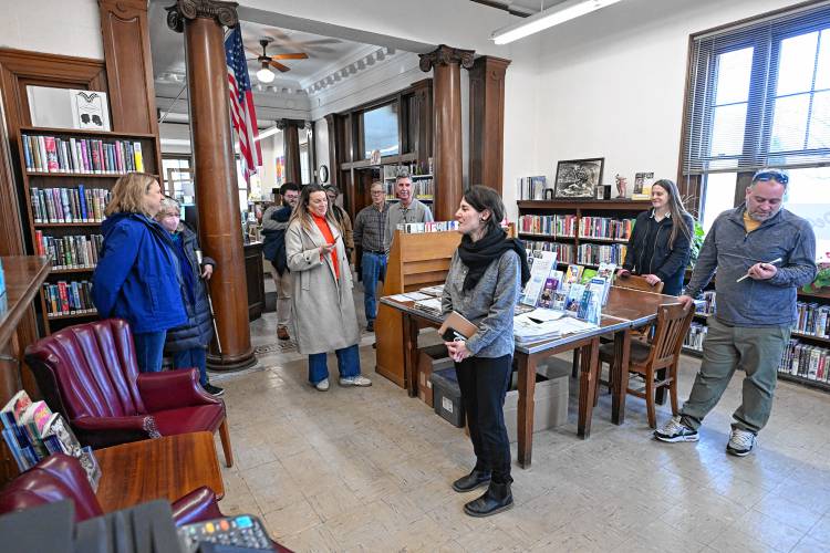 Montague Public Libraries Director Caitlin Kelley, center, answers questions as officials tour the Carnegie Public Library on Wednesday.