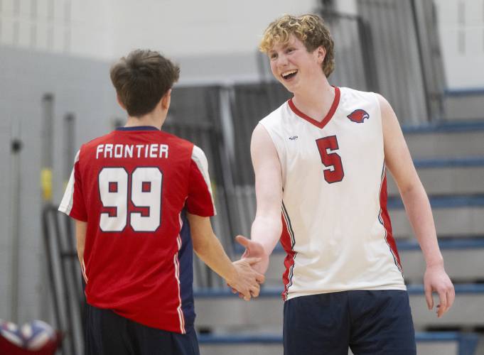 Frontier's William Petrin (5) high-fives Evan Maio (99) during the volleyball game against West Springfield at Frontier High School, Tuesday, April 8, 2025, in South Deerfield.